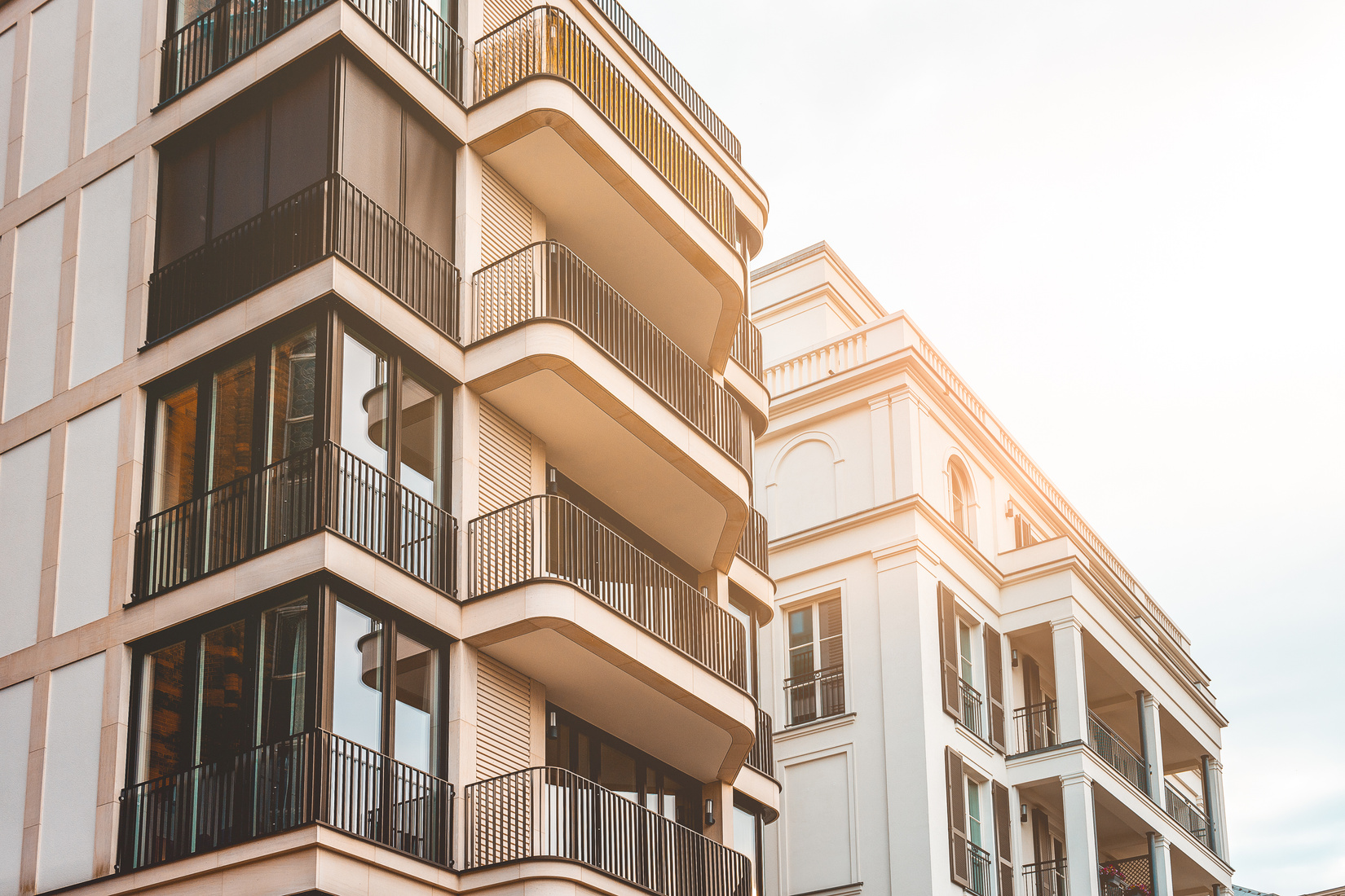 beautiful new apartment buildings with modern facade and warm sunlight for real estate themes